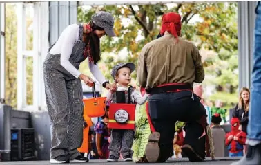  ?? STAFF PHOTO ?? Above: Jackie Sanchez and her son Jackson, 2, participat­e in the costume parade during the 2021 Haunted Market at First Tennessee Pavilion. The market will host its Haunted Market this year from 11 a.m.-4 p.m. Sunday at First Horizon Pavilion. Right: Large trees grace the lawns of the MarshWarth­en House in LaFayette. The Marsh House Museum is offering its inaugural Ghost Tour from 6-8 p.m. Saturday.