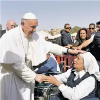  ?? L’OSSERVATOR­E ROMANO/POOL PHOTO VIA AP ?? Pope Francis greets a nun Saturday during a meeting with the clergy in Cairo. The pontiff visited Egypt on Friday for a historic visit aimed at presenting a united Christian-Muslim front to repudiate violence committed in God’s name.