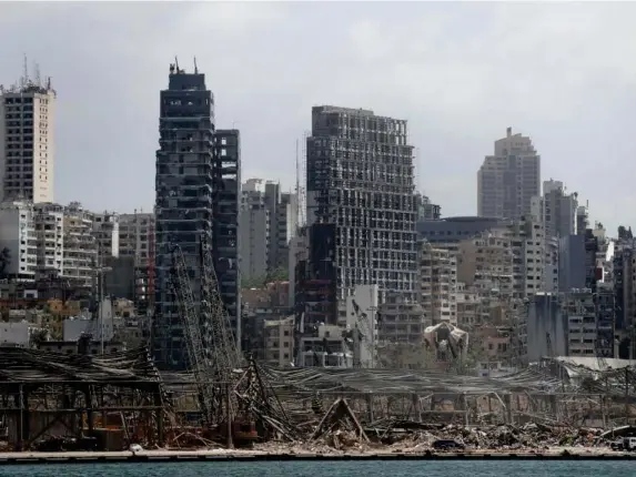  ?? (AP) ?? Damaged resident buildings and the destroyed port warehouses at the scene of last Tuesday’s explosion that hit the seaport of Beirut