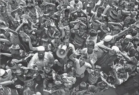  ?? DAR YASIN/AP PHOTO ?? Rohingya refugees shout slogans against repatriati­on at Unchiprang camp near Cox’s Bazar in Bangladesh on Thursday. About 1,000 Rohingya Muslim refugees demonstrat­ed Thursday at a camp in Bangladesh against plans to repatriate them to Myanmar, from where hundreds of thousands fled army-led violence last year.