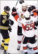  ?? The Associated Press ?? Ottawa Senators right wing Bobby Ryan, facing front, celebrates with teammates after his game-winning goal against the Boston Bruins during Game 3 of their first-round NHL playoff series in Boston on Monday.The Senators won 4-3 in OT.