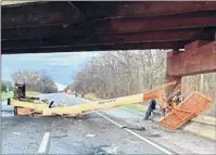  ?? New York State Police ?? This boom lift driven by a driver for Admar Constructi­on hit a Northway overpass in Clifton Park Wednesday morning, forcing the highway southbound to close for hours.