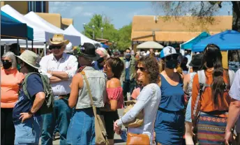  ?? WILL HOOPER/Taos News ?? Members of the public gathered for one of the first big events of the season – the Taos Farmers Market – on Saturday (May 15). With the CDC and state of New Mexico lifting the mask mandates for vaccinated individual­s, about half the patrons appeared without masks while the other half kept them on.