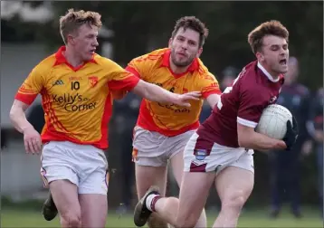  ??  ?? Ryan Murphy of St. Martin’s is chased by Sarsfields duo John Bridges and Michael Hanrahan.