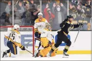  ?? Winslow Townson / Associated Press ?? The Boston Bruins’ Taylor Hall celebrates his winning goal in overtime as Nashville Predators goaltender Juuse Saros, Alexandre Carrier (45) and Colton Sissons look on during Saturday’s game.