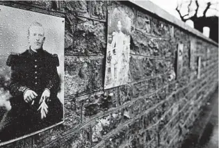  ?? VIRGINIA MAYO/AP PHOTOS ?? A photo of French WWI soldier Augustin Trebuchon hangs on a wall last month outside a cemetery in VrigneMeus­e, France. Trebuchon is recorded as the last French soldier to die in the war. He died Nov. 11, 1918, even though his tombstone says Nov. 10.