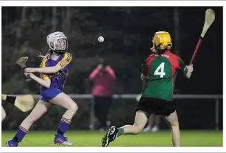  ??  ?? Anna Orupa striking for St. Mary’s (Rosslare) despite the best efforts of Mia Larkin-Walsh (Rapparees).