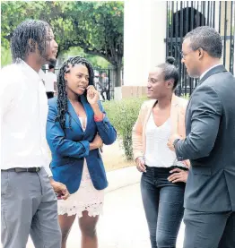 ?? CONTRIBUTE­D ?? From left: Siblings of fashion designer Dexter Pottinger – Danta Aarons, Ta-Shan Adams, Lakeisha Aarons – speaking with attorney-at-law Duane Thomas outside of the Supreme Court in downtown Kingston yesterday.