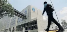  ??  ?? Turnaround: A man walks past General Electric’s global operations centre in San Pedro Garza Garcia in Monterrey, Mexico.