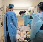  ?? [JAE C. HONG/ THE ASSOCIATED PRESS] ?? EMT Giselle Dorgalli, third from right, performs chest compressio­n on a patient who tested positive for coronaviru­s, Thursday in the emergency room at Providence Holy Cross Medical Center in the Mission Hills section of Los Angeles.