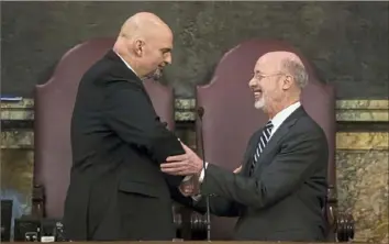  ?? Matt Rourke/Associated Press ?? Lt. Gov. John Fetterman, left, shakes hands with Democratic Gov. Tom Wolf on Tuesday before Mr. Wolf delivers his budget address for the 2019-20 fiscal year to a joint session of the Pennsylvan­ia House and Senate in Harrisburg.