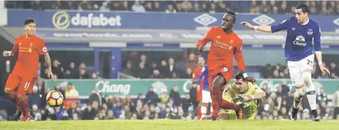  ??  ?? Sadio Mane (third right) scores a goal during the English Premier League football match against Everton at Goodison Park in Liverpool, north west England. — Reuters photo