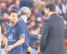  ?? — AFP photo ?? Paris Saint-Germain’s forward Messi (left) leaves the pitch after chatting with Pochettino during the French Ligue 1 match against Olympique Lyonnais at The Parc des Princes Stadium in Paris.