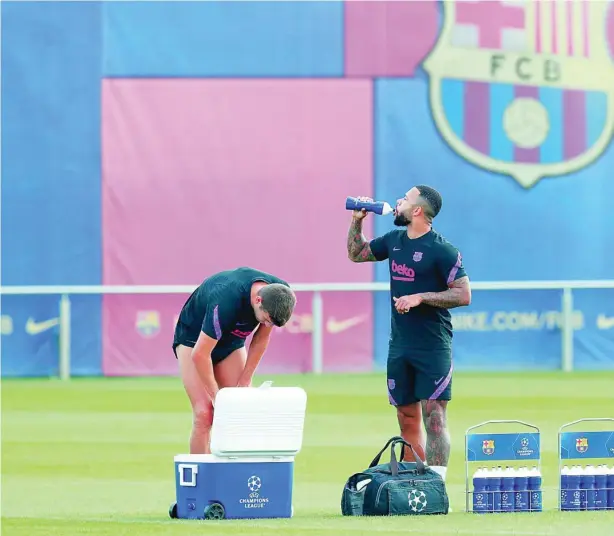  ??  ?? Memphis Depay se refresca durante el último entrenamie­nto del Barça antes del Bayern