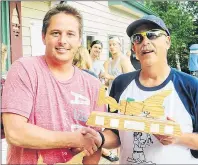  ?? &7"/ $&3&55* 5)& (6"3%*"/ ?? Chad Ceretti, left, winner of the Caseys’ 30th annual Sand Bar Golf Tournament, accepts his trophy from event organizer Ron Casey. The event ran Saturday in Seven Mile Bay.