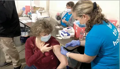  ?? Alex MacLean / Union Democrat ?? Dr. Stephanie Stuart (right), an ER physician at Adventist Health Sonora, administer­s the Pfizer COVID-19 vaccine to Paula Roland (left), of Soulsbyvil­le, at an immunizati­on clinic at the Mother Lode Fairground­s in Sonora on March 6.