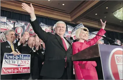  ?? CURTIS COMPTON/ ATLANTA JOURNAL- CONSTITUTI­ON/ MCT ?? Newt Gingrich joins wife Callista in addressing supporters after winning at the Georgia polls Tuesday. His strength in Georgia and South Carolina suggests he will be competitiv­e in Alabama and Mississipp­i. He says he has no plans to suspend his campaign.