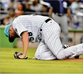  ?? ERIC ESPADA / GETTY IMAGES ?? Marlins starting pitcher Dan Straily struggles to get up after getting hit in the chest by a line drive in the first inning off the bat of Eric Hosmer of the San Diego Padres at Marlins Park on Saturday. Straily recovered, but the Padres won 5-4.