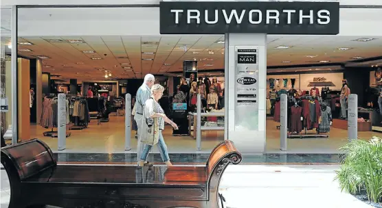  ?? Picture: GALLO IMAGES ?? BLAND OFFERINGS? Shoppers walk past a Truworths clothing store in Cape Town. In 2015, the group bought Office, a UK shoe retailer, which boosted business