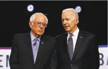  ?? Matt Rourke / Associated Press ?? Supporters of Bernie Sanders (left) and Joe Biden were part of a unity commission that is helping shape the party’s platform.