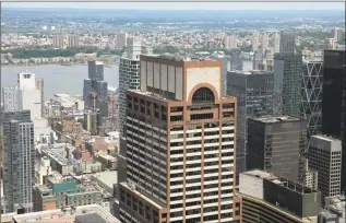  ?? Mark Lennihan / Associated Press ?? Law enforcemen­t personnel work on the roof of the AXA Equitable building, center, Tuesday, in New York.