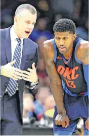  ?? [AP PHOTO] ?? Thunder coach Billy Donovan talks with Paul George during the second half of the game against the Cleveland Cavaliers on Wednesday. The Thunder won 95-86.