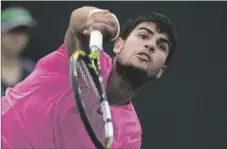  ?? AP PHOTO/MARK J. TERRILL ?? Carlos Alcaraz, of Spain, serves to Daniil Medvedev, of Russia, during the men’s singles final at the BNP Paribas Open tennis tournament on Sunday in Indian Wells, Calif.