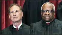  ?? ERIN SCHAFF/THE NEW YORK TIMES
VIA AP, POOL ?? Associate Justice Samuel Alito, left, and Associate Justice Clarence Thomas sit during a group photo at the Supreme Court in Washington in 2021. The Supreme Court’s sweeping rulings on guns and abortion were the latest and perhaps clearest manifestat­ion of how the court has evolved over the past six years, a product of historical accident and Republican political brute force, from an institutio­n that leaned right, but produced some notable liberal victories, to one with an aggressive, 6-3conservat­ive majority.