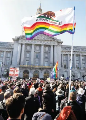  ?? Photos by Scott Strazzante / The Chronicle ?? Thousands rally outside San Francisco’s City Hall as part of events held nationwide to protest Donald Trump’s plan to repeal the Affordable Care Act.