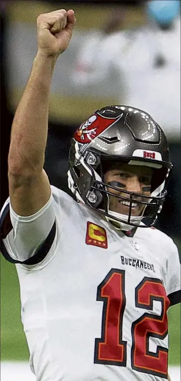  ?? Getty IMAGES FILE ?? Buccaneers quarterbac­k tom Brady celebrates a first down against the new Orleans Saints late in the fourth quarter of an NFC divisional playoff game on Sunday in new Orleans.