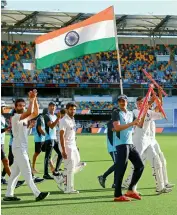  ?? AP ?? Indian captain Ajinkya Rahane (left) applauds supporters as the team takes a victory lap carrying the national flag around The Gabba in Brisbane on Tuesday. —
