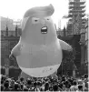  ?? PHOTO: AP/PTI ?? Opponents of Donald Trump float a six-metre blimp depicting the US president as an orange, snarling nappy-wearing baby outside the British parliament