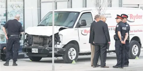  ??  ?? Investigat­ors view a damaged van seized by police after multiple people were struck at a major intersecti­on northern Toronto. — Reuters photo