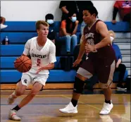  ?? RECORDER PHOTO BY NAYIRAH DOSU ?? Strathmore High School’s Kyle Olivera (5) dribbles the ball while Granite Hills’ Carlos Corona defends, Wednesday, April 14, 2021, in a basketball game at Strathmore.