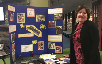  ?? SUBMITTED ?? Marianne Armstrong displays her lesson on light energy funded by the Thomas W. Mastin/Lakeland Science Classroom Grant at the Partners in Science Excellence symposium on Jan. 7.
