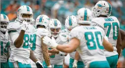  ?? ALLEN EYESTONE / THE PALM BEACH POST ?? Dolphins QB Matt Moore (center), who replaced an injured Jay Cutler, could be in the huddle again Thursday against the Ravens.