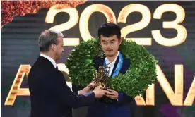  ?? Photograph: Vladislav Vodnev/Reuters ?? Ding Liren, China’s first chess world champion, is presented with his trophy by the FIDE president, Arkady Dvorkovich.