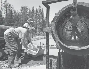  ??  ?? Northwest Montana Gold Prospector­s president Sandy Randall, front, and vice president Vickie Walborn inspect the material passing through one of the group’s trommels at their claim on Libby Creek near Libby, Mont.
