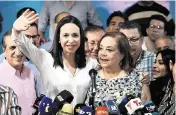  ?? FEDERICO PARRA TNS ?? Venezuelan opposition leader Maria Corina Machado, left, introduces her replacemen­t for the upcoming national elections, Corina Yoris, during a news conference in Caracas on Friday.