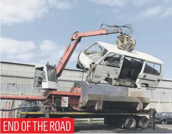  ?? Picture: Refilwe Modise ?? A taxi confiscate­d by the Joburg Metro Police Department is yesterday lifted into a crushing machine.