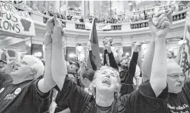  ?? John Hart / Wisconsin State Journal ?? Union members and supporters rally in 2011 to protest collective bargaining measures in the rotunda of the Wisconsin state Capitol in Madison.