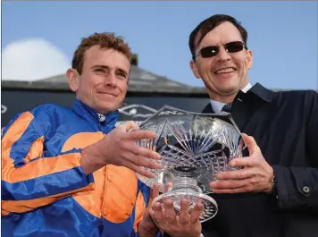  ??  ?? Jockey Ryan Moore and trainer Aidan O’Brien celebrate with the trophy after winning the Comer Group Internatio­nal Irish St Leger on Order of St George during the Longines Irish Champions Weekend 2017 at The Curragh Racecourse in Co Kildare last weekend.