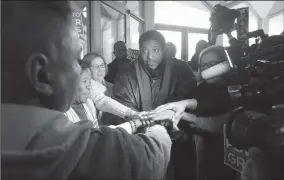  ?? ETHAN HYMAN/RALEIGH NEWS & OBSERVER ?? Rev. William Barber II huddles with protestors outside the Senate gallery during a special session of the N.C. General Assembly at the Legislativ­e Building in Raleigh, N.C., on Friday.