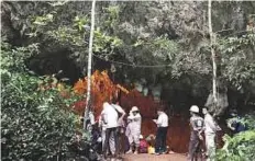  ?? Reuters ?? Rescuers are seen outside the Tham Luang caves, where 13 members of an-under 16 football team are trapped.