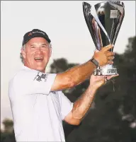  ?? Christian Petersen / Getty Images ?? Scott McCarron poses with the Charles Schwab Cup following the final round Sunday in Phoenix.