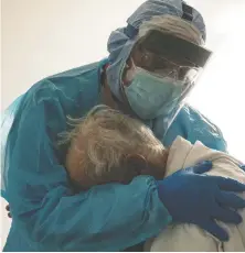  ?? GO NAKAMURA/ GETTY IMAGES ?? “He was very sad because he's in a room where he knows nobody,” says Dr. Joseph Varon in explaining a picture of him comforting an elderly patient in Houston recently.