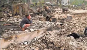  ?? JOHN LOCHER/AP ?? Desiree Pierce cries as she visits her fire-destroyed home Friday in Talent, Ore. “I just needed to see it, to get some closure,” she said.