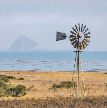  ?? Allen J. Schaben Los Angeles Times ?? A WINDMILL in Cayucos, Calif. Castle Wind has entered a deal with the city of Morro Bay to gain access to the city’s power grid connection if offshore wind developmen­t is approved in California.