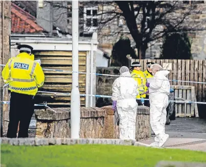  ??  ?? Police and forensics officers at the scene of the alleged murder at a flat on Victoria Road, Kirkcaldy.