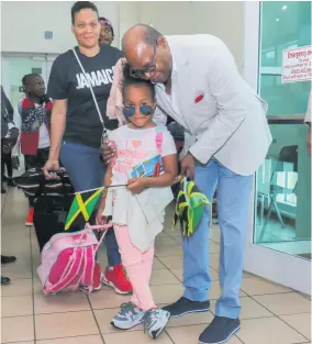  ??  ?? Minister of Tourism Edmund Bartlett shares a sweet moment with Kaycee Forbes.